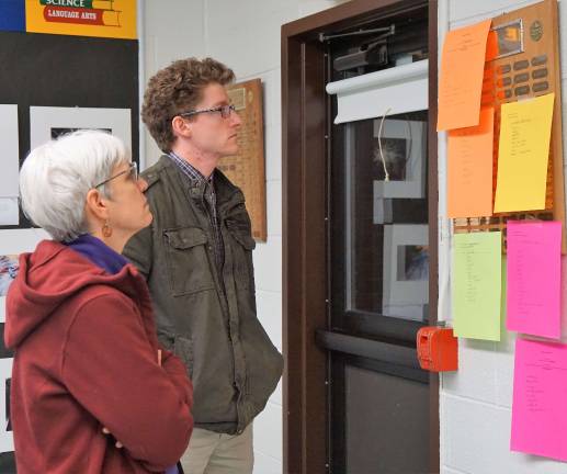 PHOTOS BY VERA OLINSKI From left, Annie Colonna and Conor Brennan reflect on completed stigma activity brainstorm sheets.