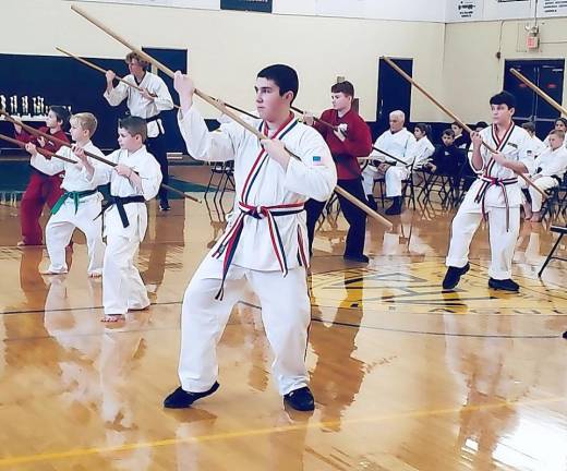 Braden Rosario and his fellow students perform an Okinawan Kobudo (Weapons) Kata during the Winterfest Karate Tournament.