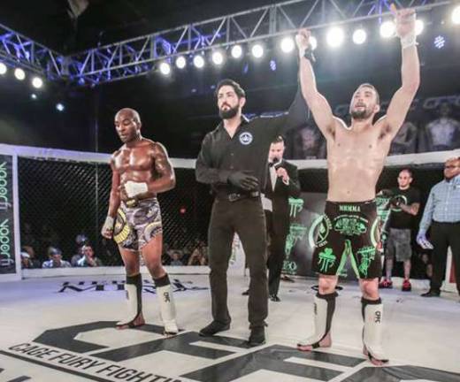 Jim Fitzpatrick (right) has his hand raised following his unanimous decision victory over Bobby Malcolm (left) at CFFC 65.