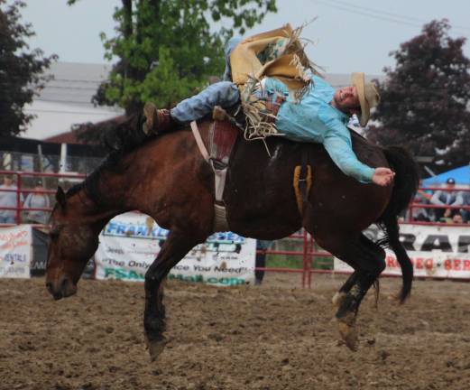 Rain doesn't damper Sussex Christian Rodeo Tim Kent of Greencastle, Pa., is shown bareback riding.