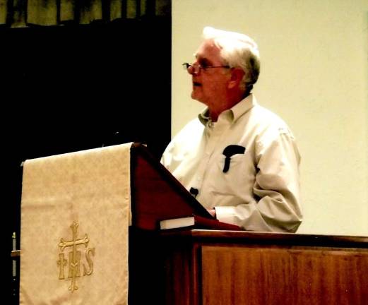 Photo by Viktoria-Leigh Wagner Arthur Van Houten, amember of the church for eight years, is seen reciting his original poem, &quot;The Big White Church Up on the Hill.&quot;