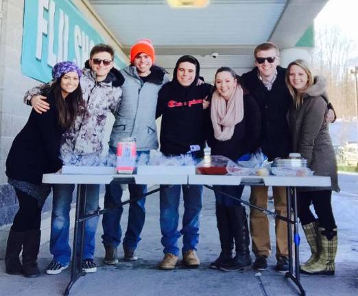 DECA donates to The Seeing Eye DECA members braved the cold this month to raise money for the Seeing Eye Association with a bake sale outside the Vernon A&P.