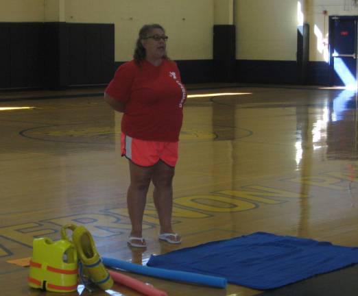 Ms. Sarah of the YMCA explains water safety and precautions to the Safety Town youngsters at the Tuesday Aug. 1 program.