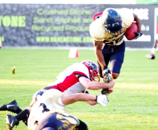 Sussex Stags running back Rasheed Nelson goes airborne in an attempt to avoid being tackled.