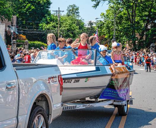 Sparta. Fourth of July events Children ride in a Lake Mohawk Ski Hawks boat in the parade.
