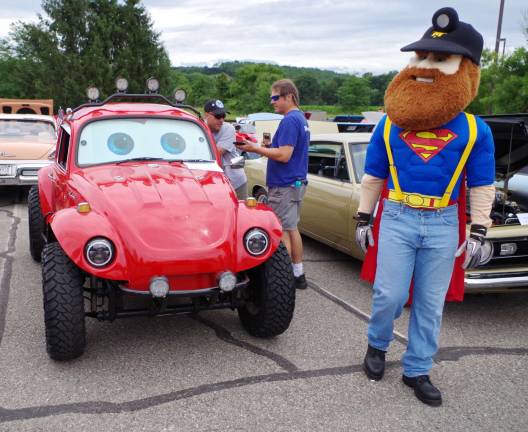 Herbie the Sussex County Miner tours the rows of classic vehicles on display.