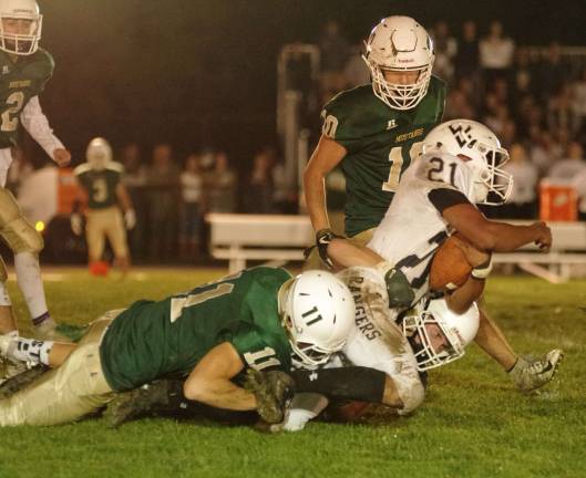 After a long gain Wallkill Valley ball carrier Justin Rivera is taken down by Sussex Tech defenders in the first quarter.