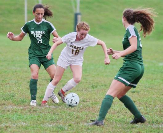 Vernon's Catherine McCabe maneuvers the ball between two opponents.