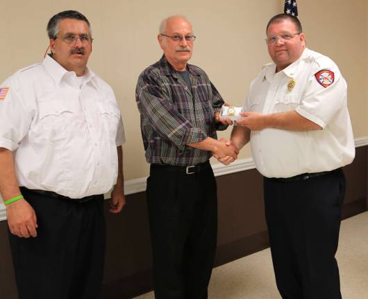 Robert Stormes Jr. receives award for 30 years service with the Sussex Fire Dept. presented by Chief Jake Little and Assistant Chief Andrew Boutillette.