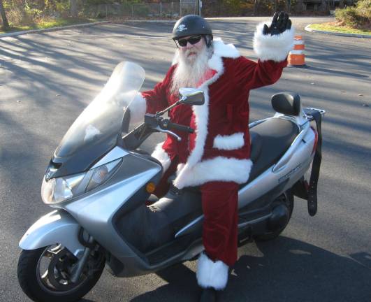 This Santa gets around on a motorcycle.