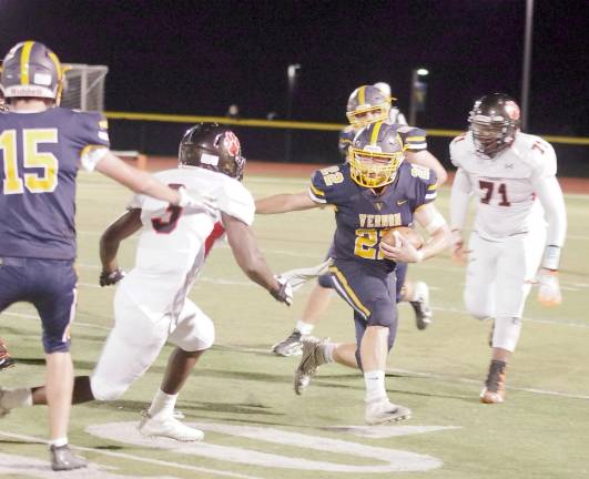 Vernon ball carrier Collin Andriola speeds towards the outside as Hackettstown defenders close in during a play. Andriola rushed for 202 yards resulting in 3 touchdowns