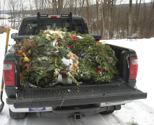 Group removes wreaths at season's end One of the two pick-up trucks cleaned up the cemetery in no time.