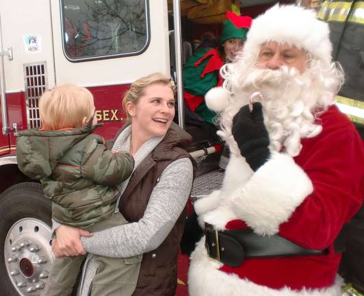Santa Claus rides through Lake Neepaulin Meg Gardener (Alder Terrace) introduces her son, Boden, to Santa for the first time.