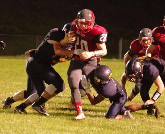 High Point ball carrier Davis Dvorak (20) is set upon by Jefferson defenders in the second half.