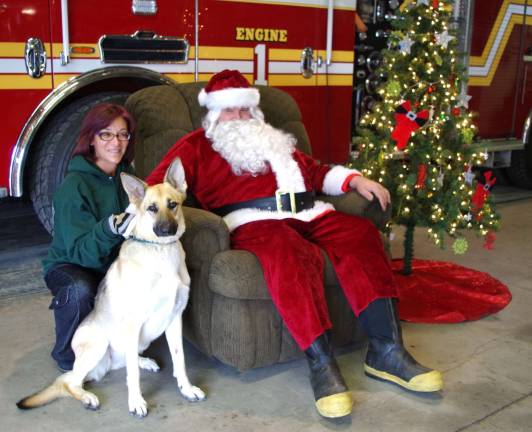 Linda Pellitteri of Great Gorge Village poses with Santa and her German Shepard Lucy. This was the fourth year in a row that she brought her dog to the photo op at the firehouse.