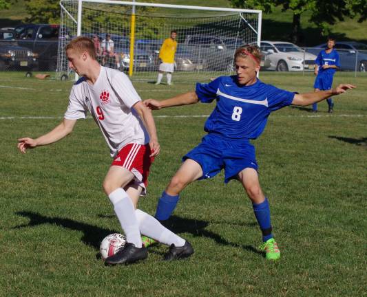 High Point's William Frye and Kittatinny's Devon Olasin battle for control of the ball.