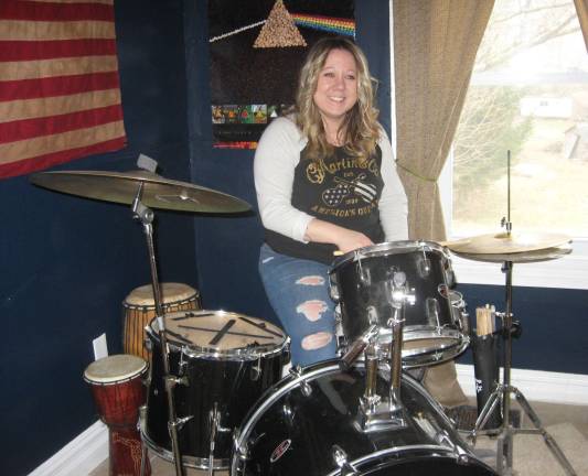 Tina happily drums.