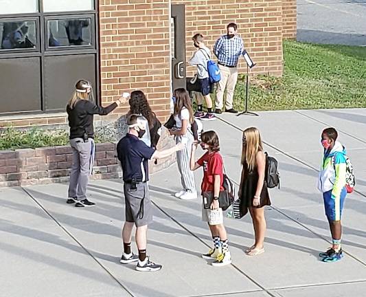 Students return practicing ‘The Glen Meadow Way’ Morning temperature check (Photo provided)