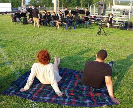 A couple is shown enjoying the music of the High Point Jazz Ensemble under the direction of James Aslanian.