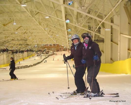 Joe Hession turns on the snow guns at his new, indoor ski resort John and Buffy Whiting of Vernon stand at the top of the slope at BIG Snow on the day of their reopening last December (Photo by Dr. John T. Whiting)