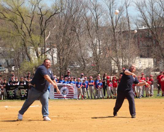 Chief of Sussex Fire Department, Jake Little and Wantage Fire Department Chief Larry Bono throw the first pitch at the Wantage Little League opening day.