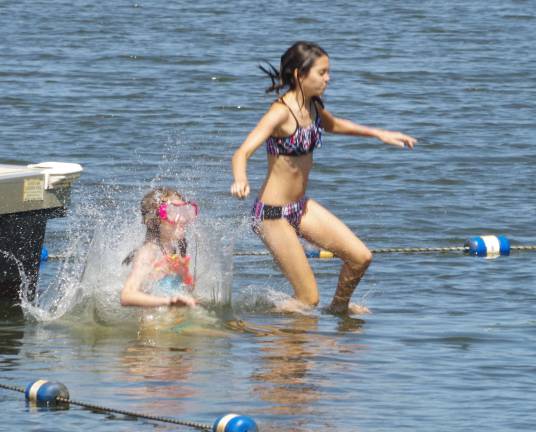 Despite gusty and chilling winds as a result of tropical storm Hermine, these girls felt compelled to enjoy what might likely be their last day at the Barry Lakes beach as the summer season winds down.