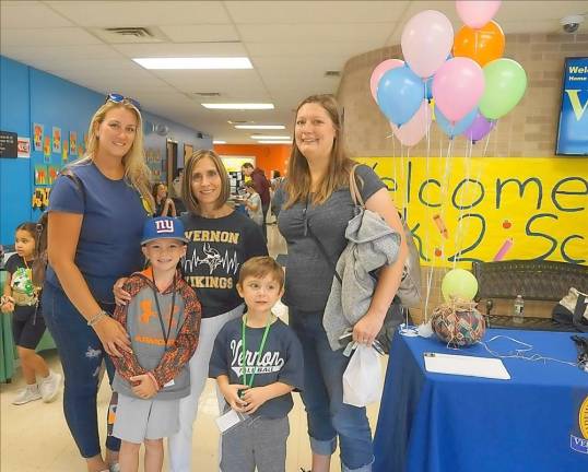 Cedar Mountain School Principal Rosemary Gebhardt poses with two school Community Association officers and their children.