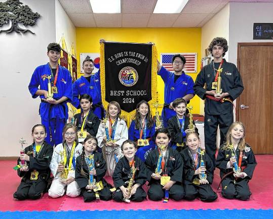 Master Ken’s Xtreme Martial Arts Center honored Master Ken’s Xtreme Martial Arts Center in Hamburg was named the best school at the U.S. Hong Ik Taekwondo Championship at Queens College. Students in the first row, from left, are Lianna Mehmedi of Hardyston, Natalia Daronco of Wantage, Annastasia Rodriguez of Sparta, Reed Bourne of Wantage, Alex Lorenzo of Franklin, Sophie Sylvestri of Wantage and Gina Campa of Hardyston. In the second row, from left, are Jake Klein of Hamburg, Timmy Lorenzo of Franklin, Lincoln Luedtke of Hamburg, Mirae Lee of Hamburg, Matthew Ciccone of Hardyston and Lucio Campa of Hardyston. Holding the flag are Nathan Henry, left, and Evan Zhang.