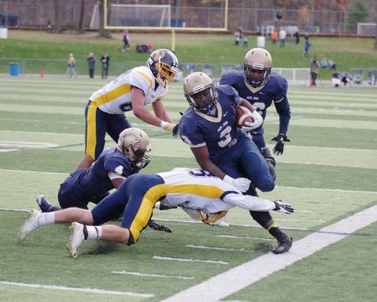 Pope John ball carrier Berrell Neal is knocked out of bounds by the Vernon defense. Neal rushed for 128 yards and scored three touchdowns.