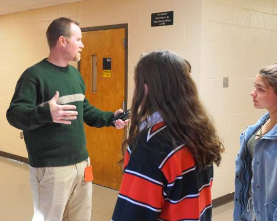 On left, Principal Jonathan Tallamy gives instructions to students.