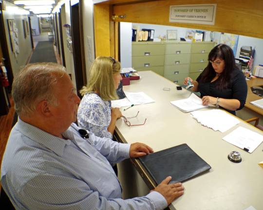Vernon Township Council incumbent candidate Dan Kadish, left, and candidate Sandy Ooms wait as Township Clerk Kauren Kirkman inspects their petitions for the Nov. 3 general election.