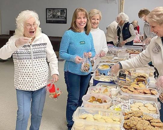 Maureen Blandino (left) attests to the deliciousness of the fresh cookies baked by Vernon Township Woman’s Club members for their annual Cookie Project. Sharing a laugh with her are (l to r) Lisa Mills, Angela Peacock and Fran Janusko.