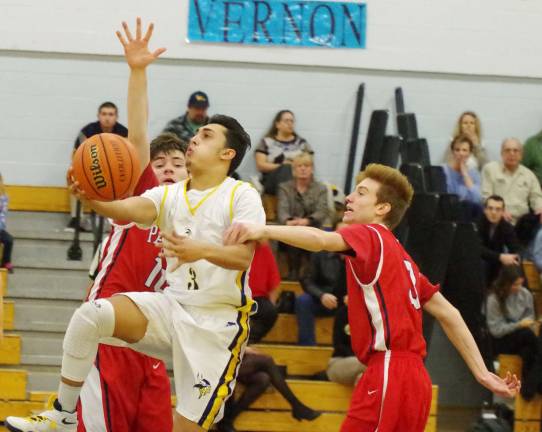 Vernon's Jacob Rodriguez breaks through Lenape Valley's defense towards the basket.