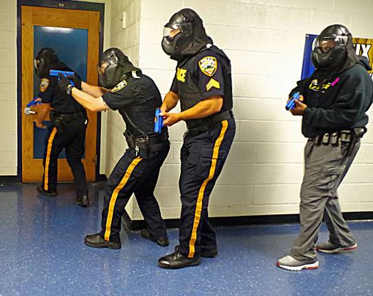 Four Vernon police officers are shown looking for an active shooter in a series of drills held at Lounsberry Hollow Middle School.