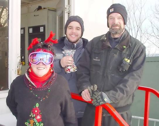Buffy Whiting presents lift operator and friend Sean with a bag of Christmas cookies
