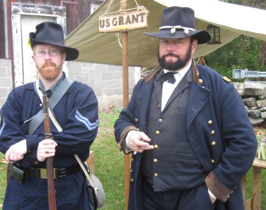 Living history comes to Glenwood Andrew Cullen (left) and Ken Serfass, portraying General Grant, survey the camp.