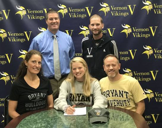 Maddie Labance, center, signs her national letter of intent to play soccer at Bryant University.