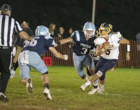 Vernon quarterback R.J. Mehr is on the run with the ball in the first half.