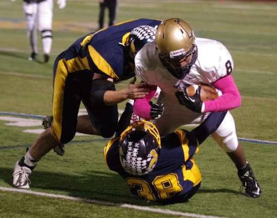 Pope John Lion Wayne Patterson tackled by a pair of Vernon Vikings.