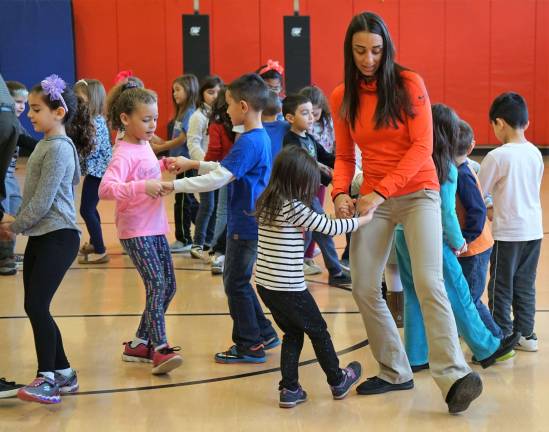Phys. Ed. teacher Michele Gonnelli dances with students.