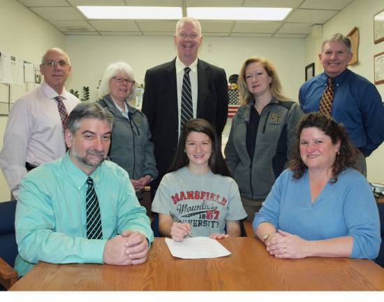 Letter signing Vernon's Julie Cacace signs a national letter of intent to play field hockey at Mansfield University. Cacace, front center is flanked by her parents, Mark Cacace, left, and her mother Carolyn Cace. In back, from left, are: athletic director Bill Edelman, assistant field hockey coach Sherry Quinn, Principal Timi Dunnigan, head field hockey coach Hollyce Schoepp and Guidance Director Ray Morris.