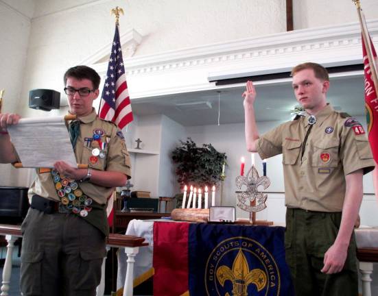 New Eagle scout Steven Schneider of Troop 404 is swon in by Eagle Scout Dominic DellAntonia of Troop 192.
