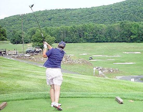 Joan Huffine hits her tee shot to qualify in the Ladies 65 years and over Division (Dr. John T. Whiting)