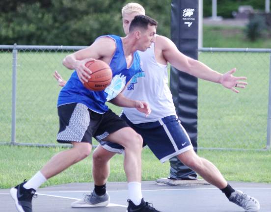 Team Tobin's Almin Hodzic dribbles the ball while covered by Team Smalley's Derek Hall.