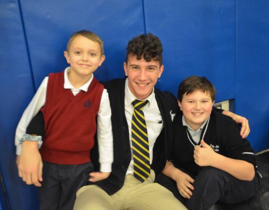 From left, Reverend George A. Brown Memorial School third grade student Gabriel Krause, Pope John XXIII Regional High School senior Chase Nugnes, and Pope John XXIII Middle School sixth grade student Quinn Muli pose for a picture during a Linking Lions meeting in December at Reverend George A. Brown Memorial School in Sparta.