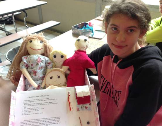 Middle School students celebrate Colonial Day Madison Lungren is shown with dolls.