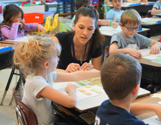 Cedar Mountain teachers honored Kelly Talerico works with a student.