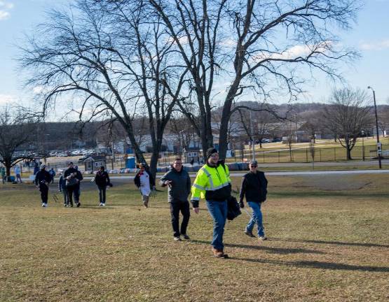 Golfers on their way to begin the annual Chili Open Golf Classic on a makeshift course at Sussex County Fairgrounds.