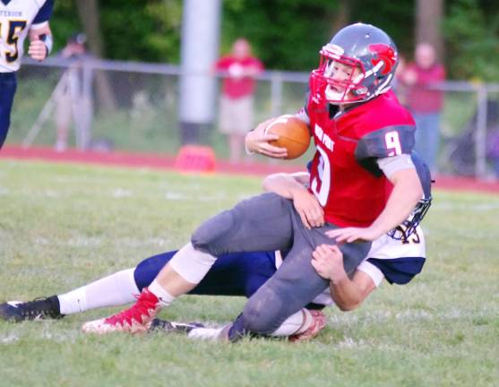 High Point quarterback Jacob Liscinsky is tackled by Jefferson defender Paul Monaco in the first quarter.