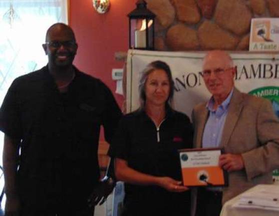 Eileen Reinhagen-Wurst &#x2013;ACME Store Manager &amp; Arther Shanklin &#x2013;Bakery Manager, accept Best Presentation award from Elmer Platz, Vernon Chamber President.